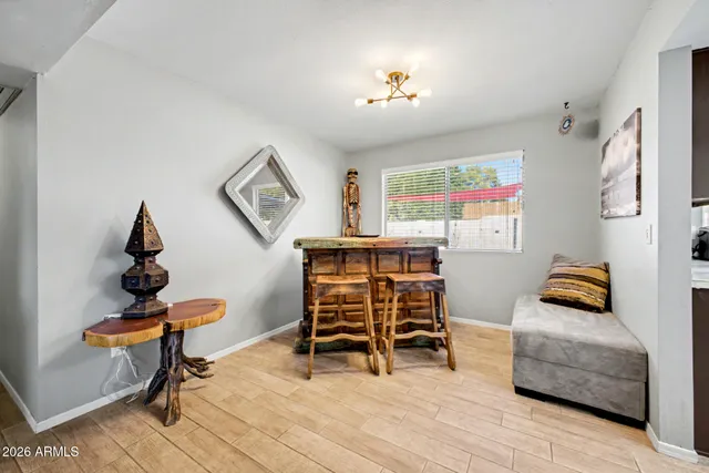 a living room with furniture and a painting on the wall