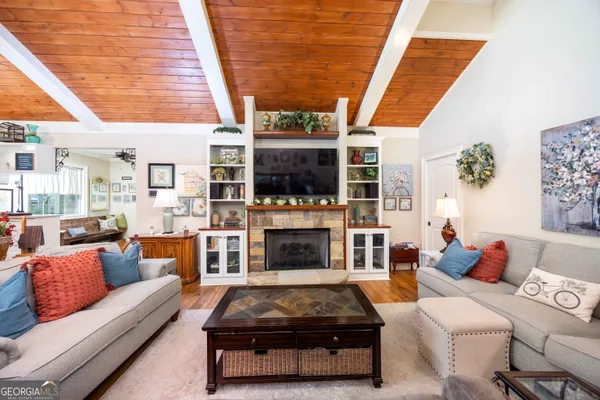 a living room with furniture a fireplace and a flat screen tv
