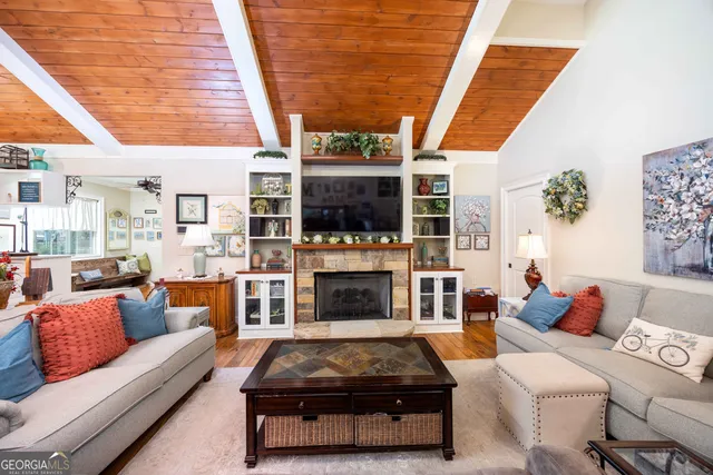 a living room with furniture a fireplace and a flat screen tv