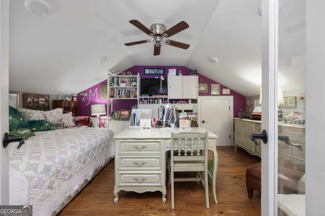 a kitchen with a refrigerator a stove a microwave oven a sink dishwasher and white cabinets with wooden floor