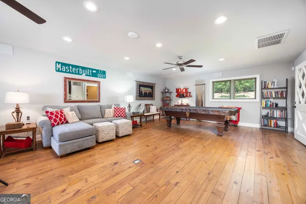 a living room with lots of furniture and a chandelier