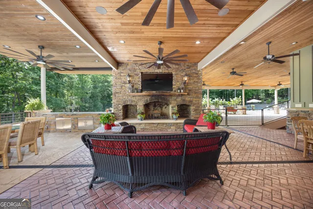 a view of a house with backyard and sitting area