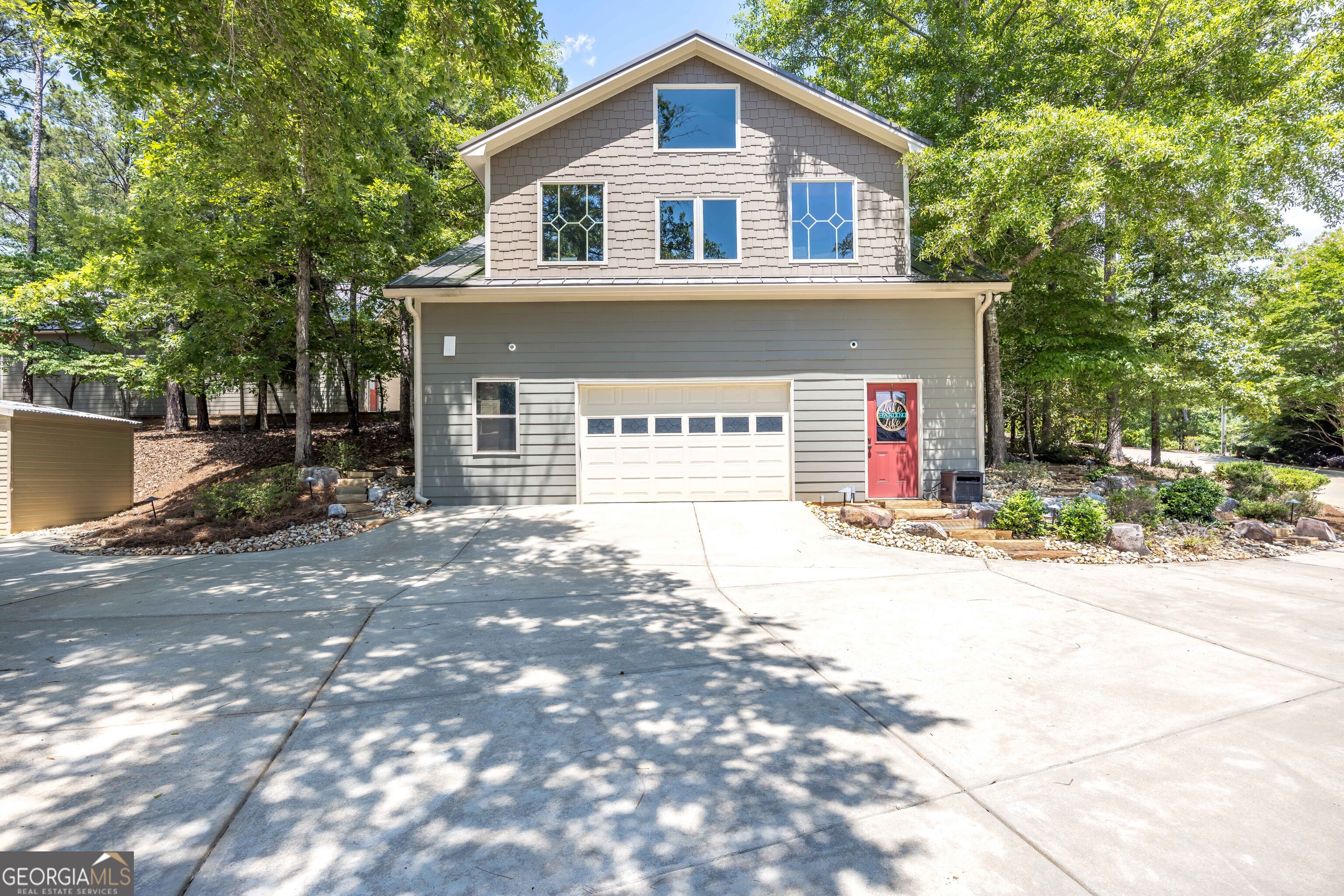 1132 Boat Club Road Hamilton, GA 31811 - Photo 49 of 50 a front view of a house with a yard and garage