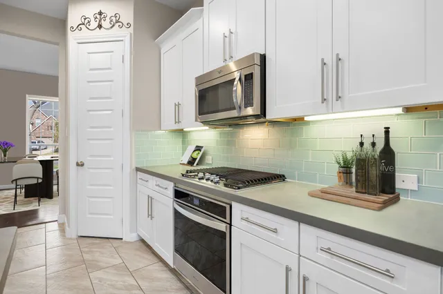 a kitchen with stainless steel appliances granite countertop a refrigerator sink and cabinets
