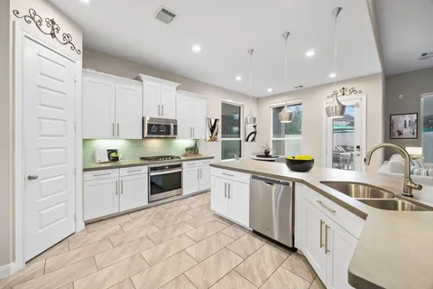 a kitchen with stainless steel appliances granite countertop a sink and a stove