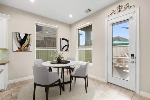 a kitchen with a table and chairs in it