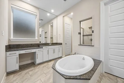 a bedroom with furniture and a large window