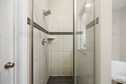 a bathroom with a granite countertop sink mirror and bathtub