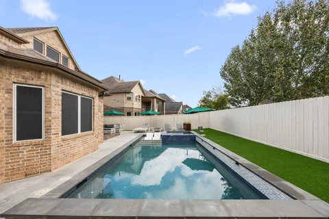 a view of house with a yard