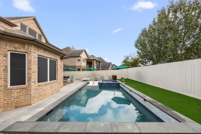 a view of house with a yard