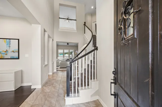 a view of entryway with stairs and a livingroom