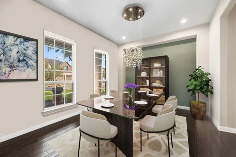 a dining room with furniture potted plants and wooden floor