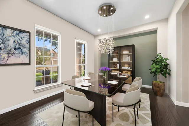 a dining room with furniture potted plants and wooden floor