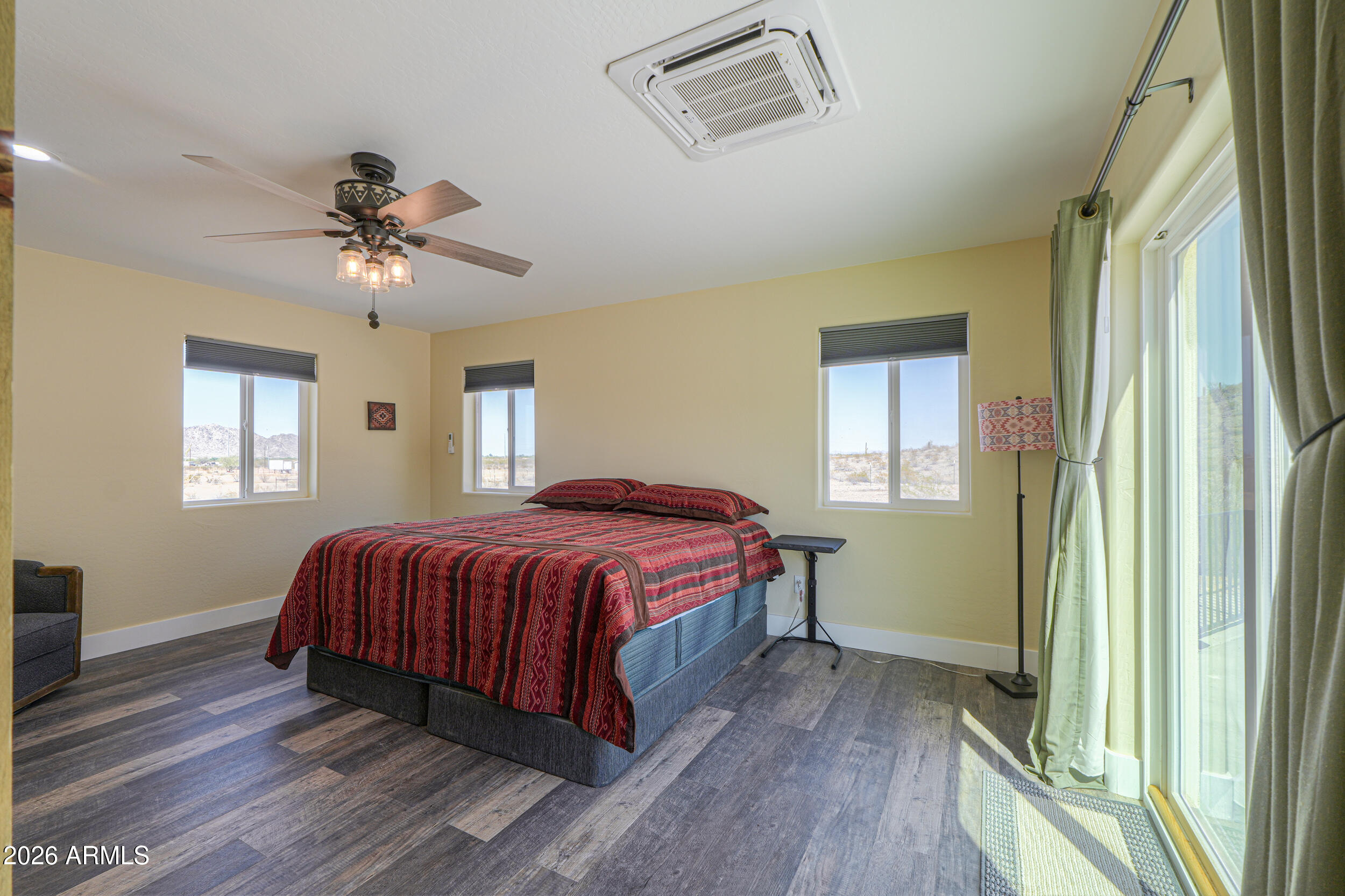 0 West Quail Run Road Maricopa, AZ 85139 - Photo 14 of 49 a spacious bedroom with a bed and a chandelier