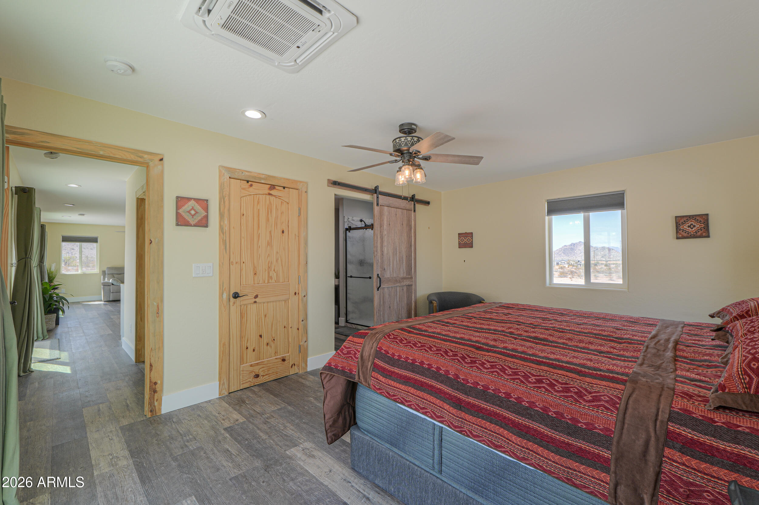 0 West Quail Run Road Maricopa, AZ 85139 - Photo 15 of 49 a bedroom with a bed and a chandelier