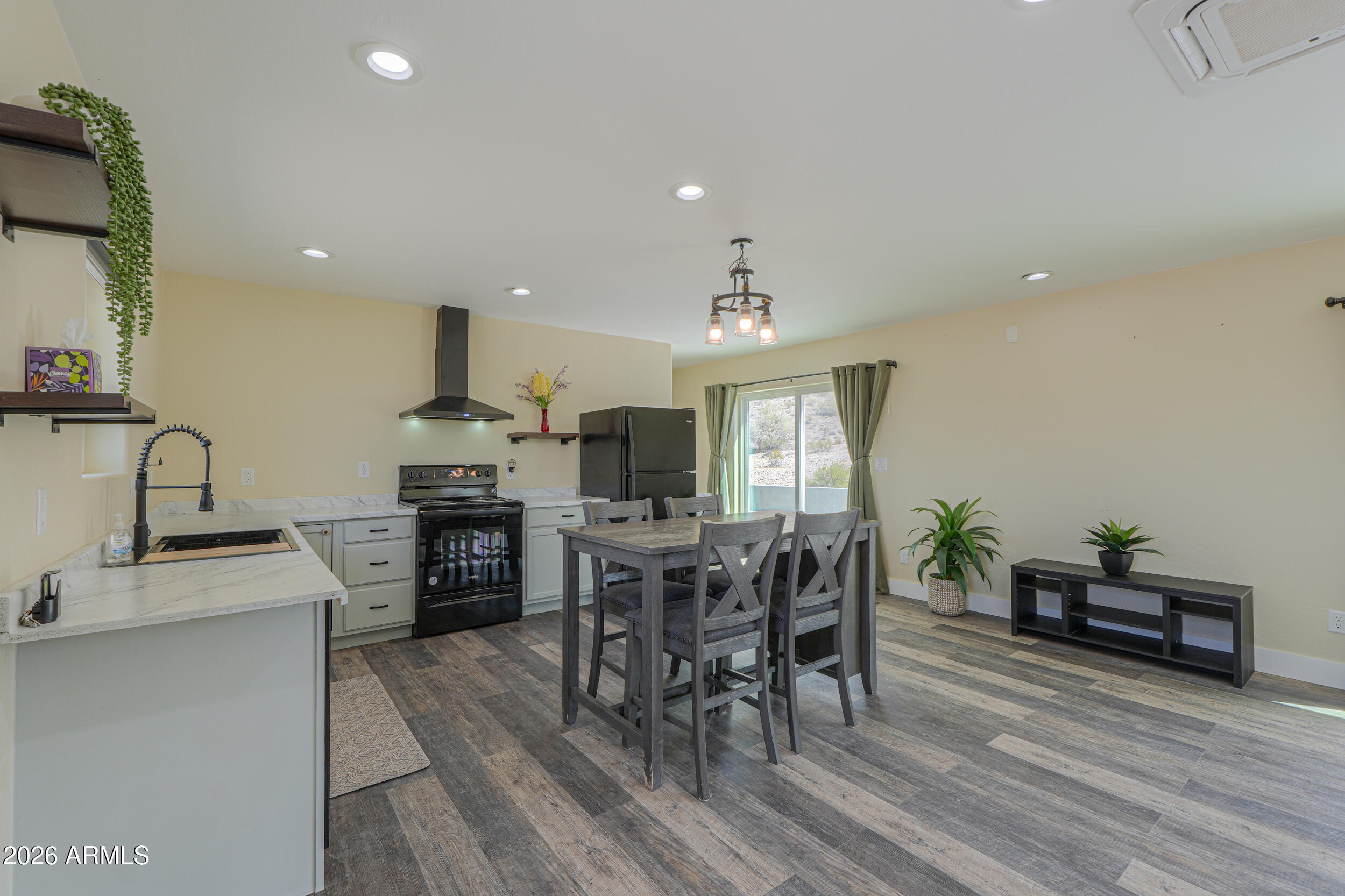 0 West Quail Run Road Maricopa, AZ 85139 - Photo 5 of 49 a view of a dining room with furniture and wooden floor