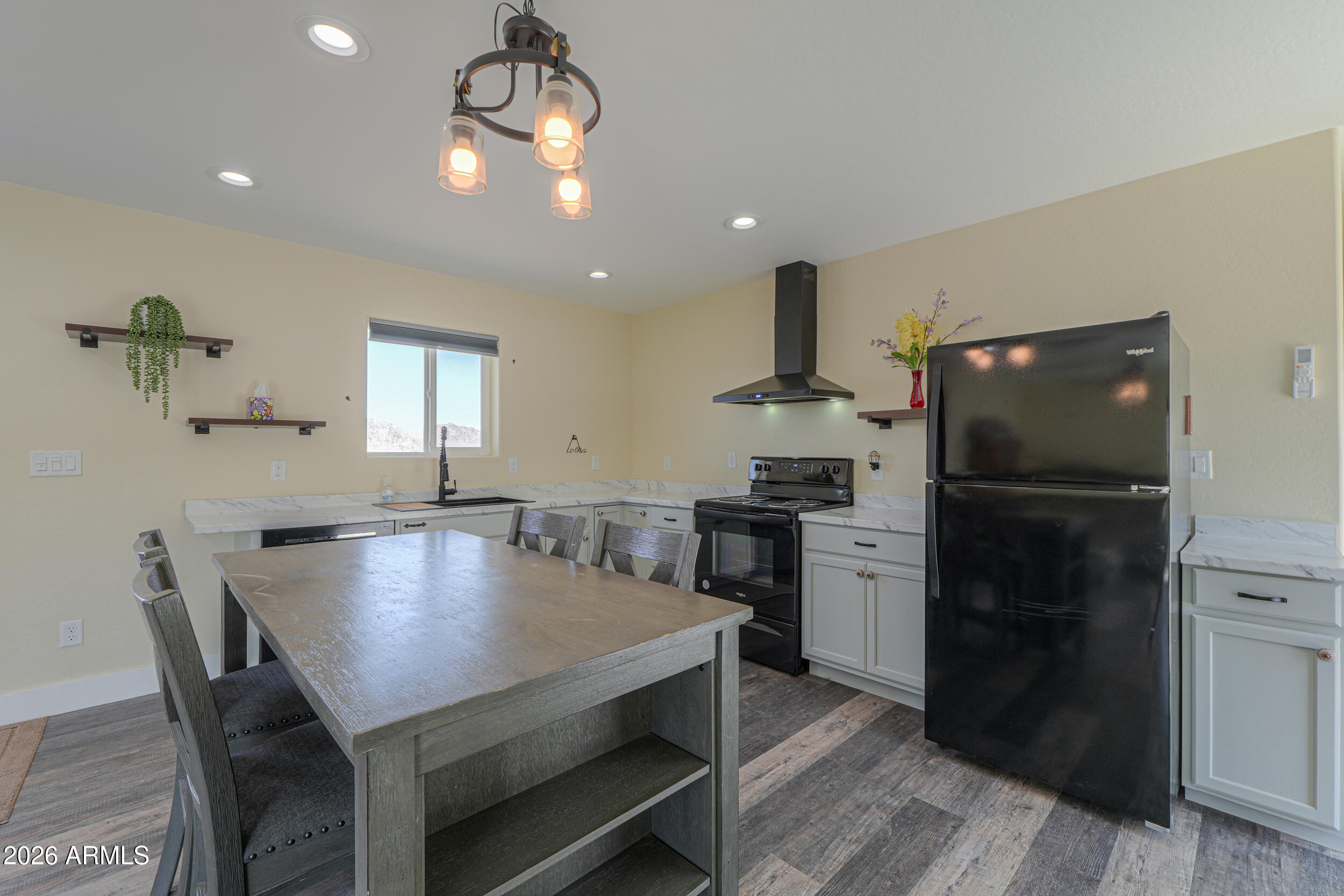 0 West Quail Run Road Maricopa, AZ 85139 - Photo 9 of 49 a kitchen with a table chairs refrigerator and microwave