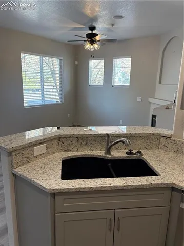a kitchen with a sink and a stove