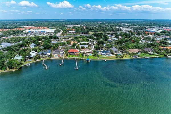 an aerial view of a house with a big yard