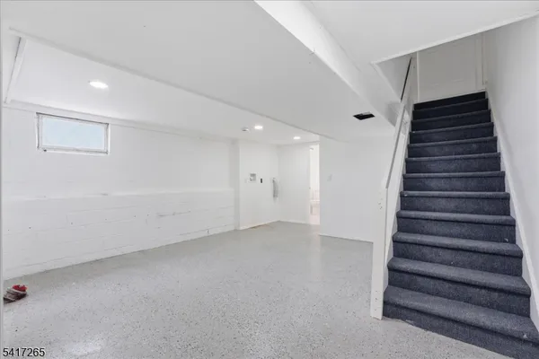 a view of an empty room with stairs
