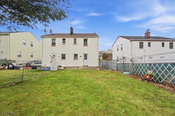a view of a house with backyard sitting area and garden