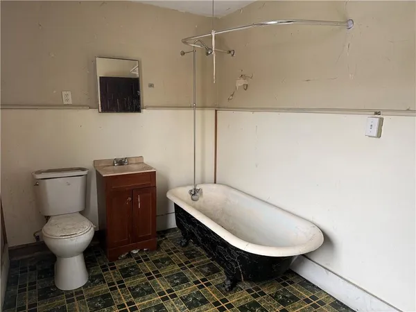 a bathroom with a toilet a sink and bathtub