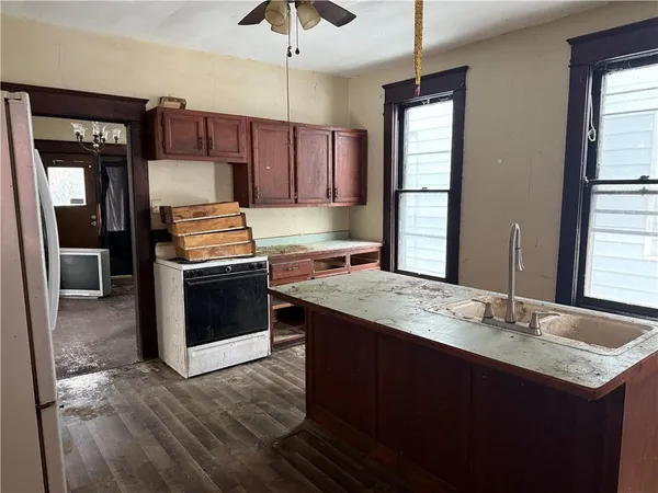 a kitchen with a sink stove and refrigerator