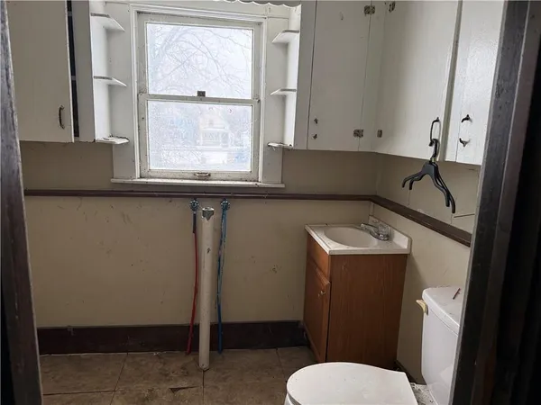 a bathroom with a toilet sink and window