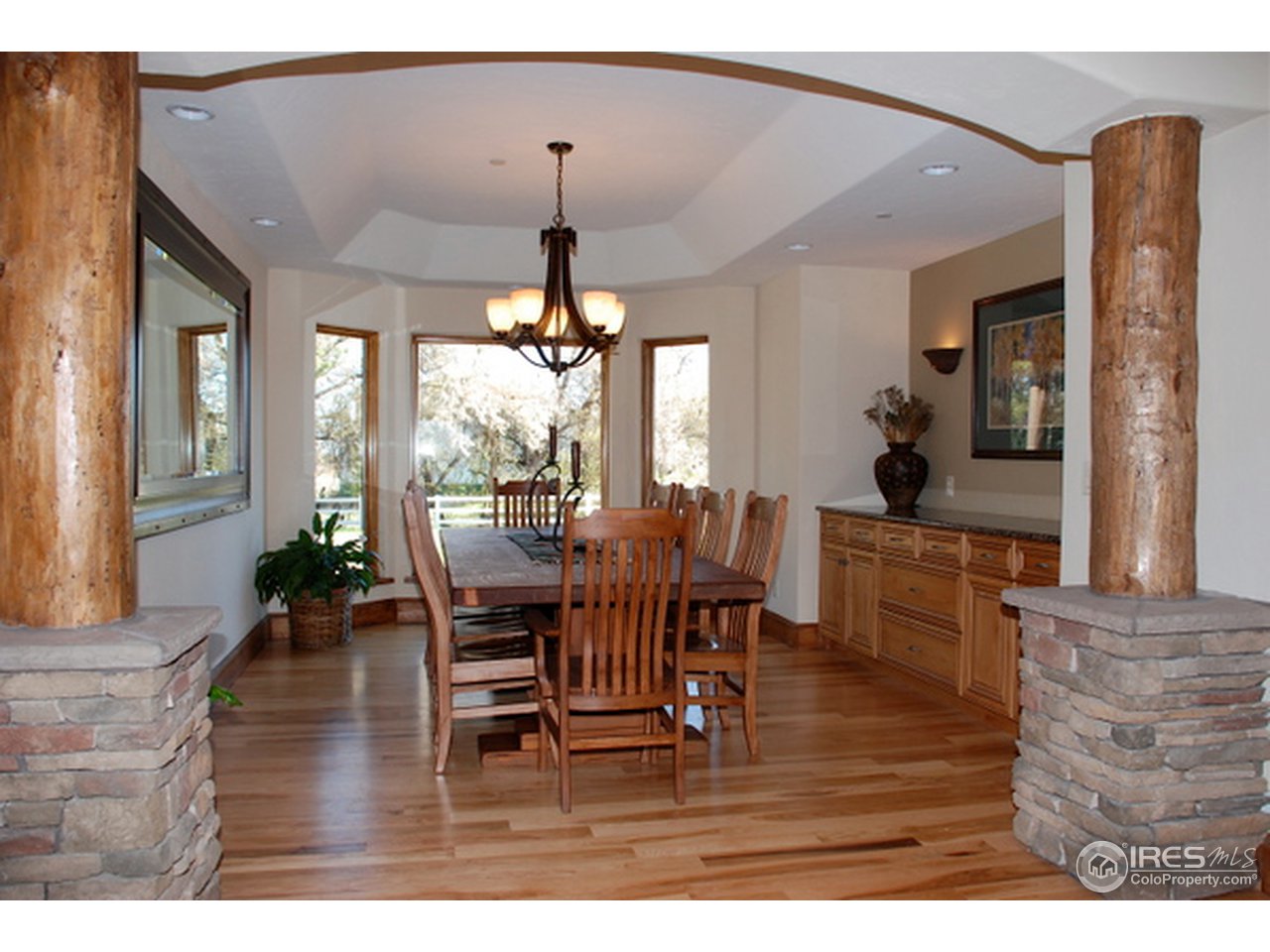7861 Valmont Road Boulder, CO 80301 - Photo 4 of 13 a view of dining room and livingroom with furniture wooden floor a chandelier