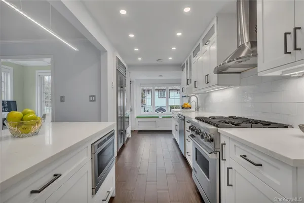 a kitchen with stainless steel appliances a sink stove and refrigerator