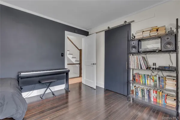 a view of entryway and hall with wooden floor