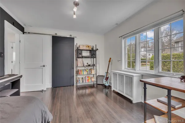 a bedroom with furniture and a wooden floor