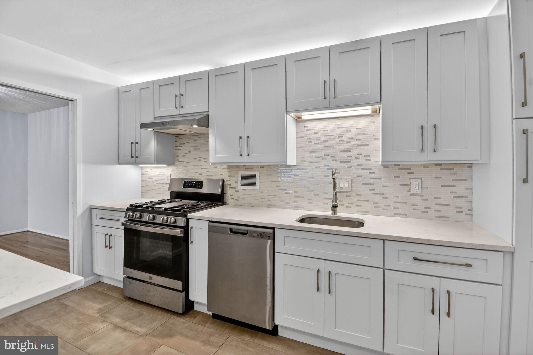 5500 Friendship Boulevard, Unit 1714N Chevy Chase, MD 20815 - Photo 1 of 53 a kitchen with white cabinets and white appliances