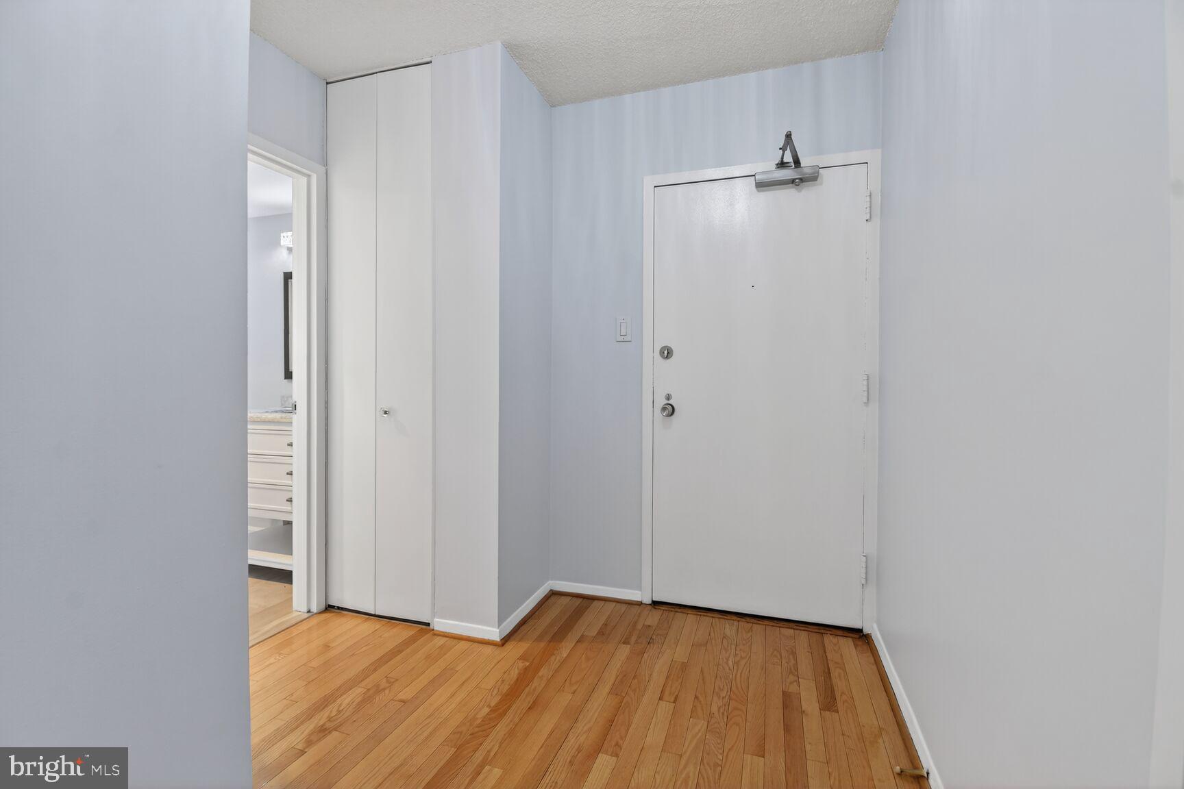 5500 Friendship Boulevard, Unit 1714N Chevy Chase, MD 20815 - Photo 3 of 53 a view of an empty room with wooden floor