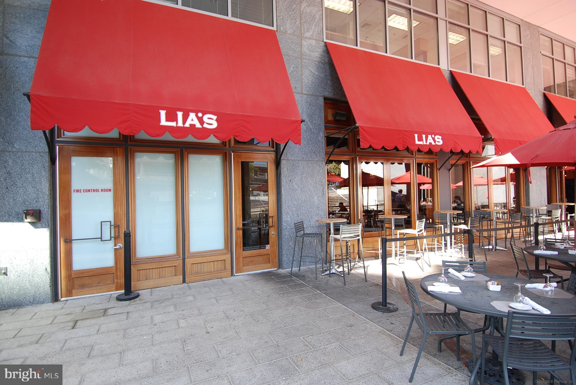5500 Friendship Boulevard, Unit 1714N Chevy Chase, MD 20815 - Photo 48 of 53 a view of a cafe with a table and chairs under an umbrella