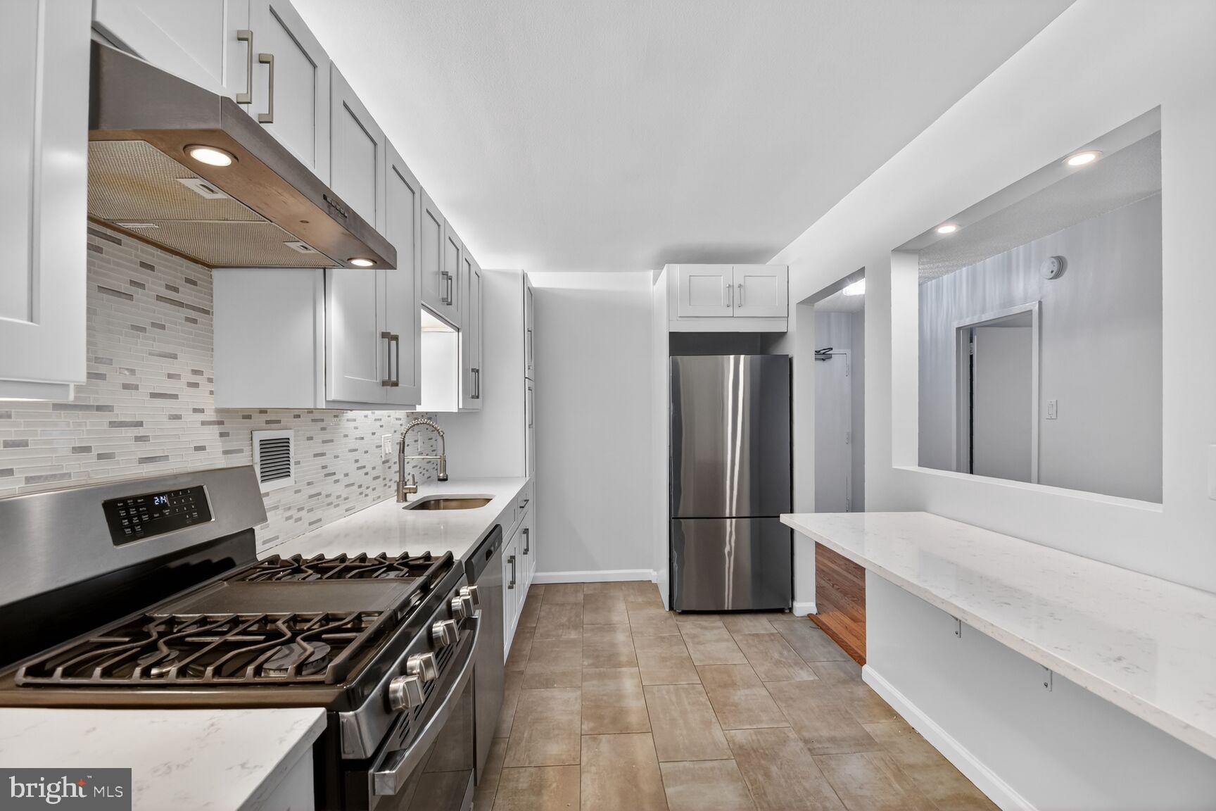 5500 Friendship Boulevard, Unit 1714N Chevy Chase, MD 20815 - Photo 8 of 53 a kitchen with stainless steel appliances a stove a sink and a refrigerator
