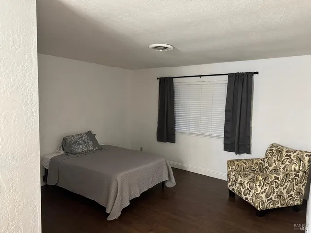 a bedroom with a bed and a couch