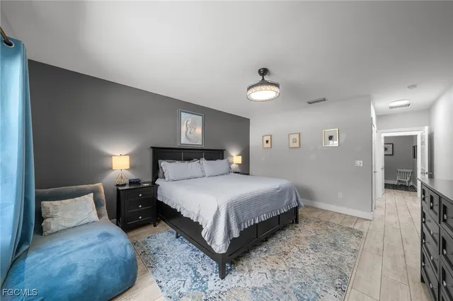 a bedroom with a bed and a lamp