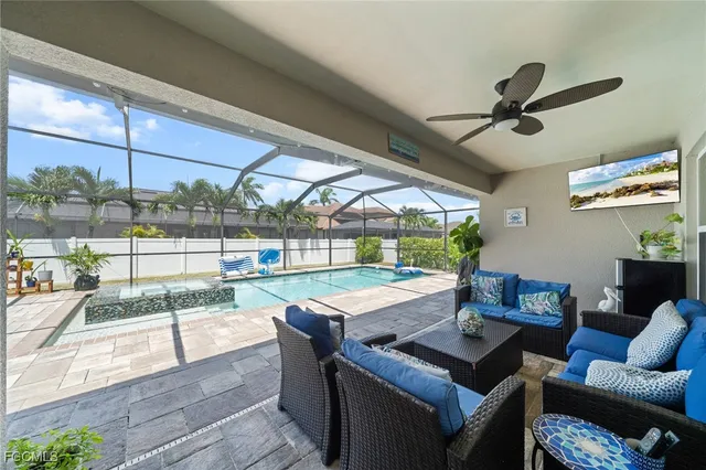 a view of a patio with couches chairs and a floor to ceiling window