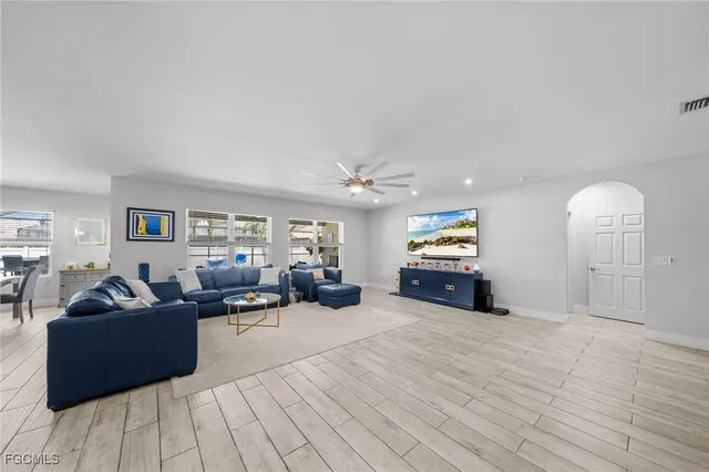 a living room with furniture and wooden floor