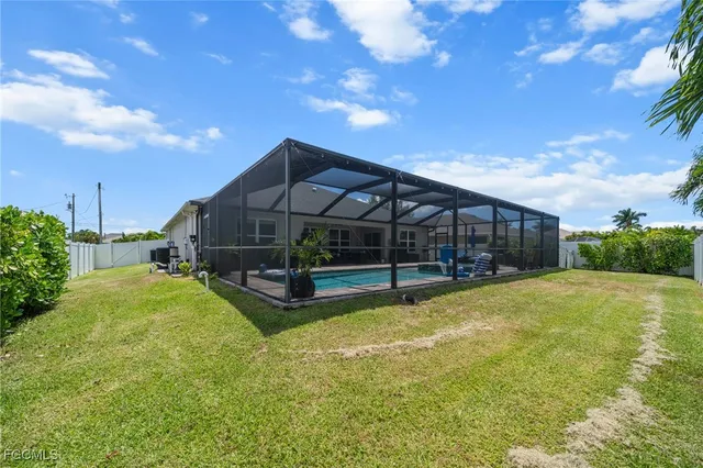 a view of a house with a yard and sitting area