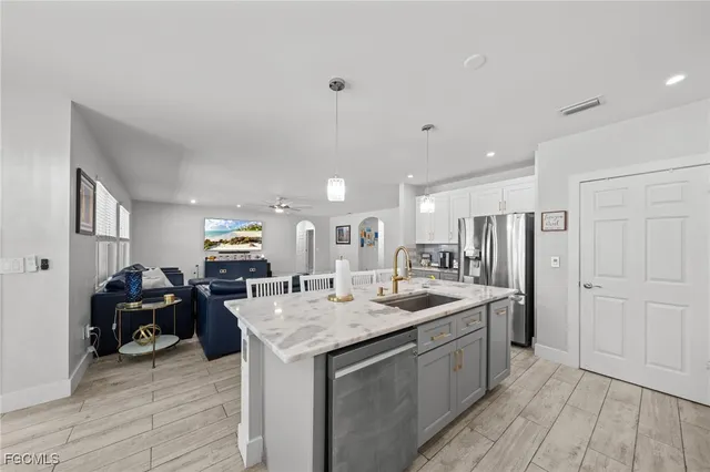 a kitchen with stainless steel appliances granite countertop a sink stove and refrigerator