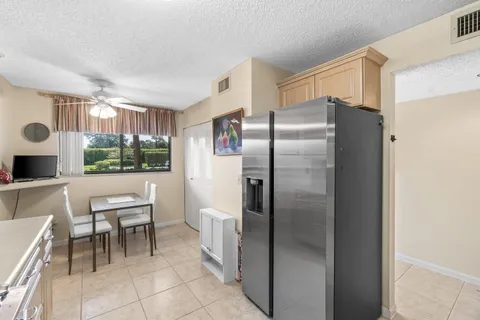 a kitchen with a refrigerator and table