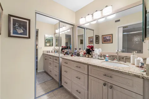 a spacious bathroom with a double vanity sink mirror and shower