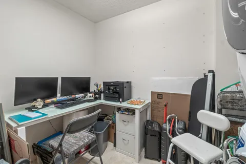 a view of a workspace with furniture and a flat screen tv
