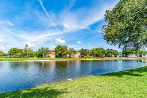 a view of a lake with houses in the back