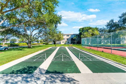 a view of yard with swimming pool and green space