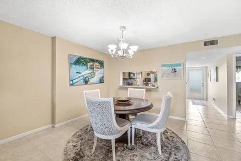 a dining room with furniture a rug and a chandelier