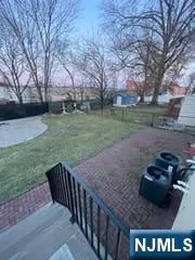 a view of a backyard with wooden fence