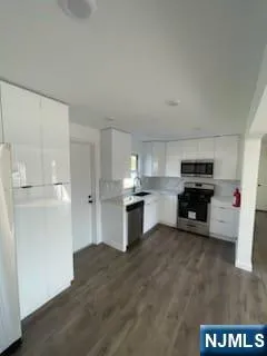 a kitchen with granite countertop a refrigerator and a stove